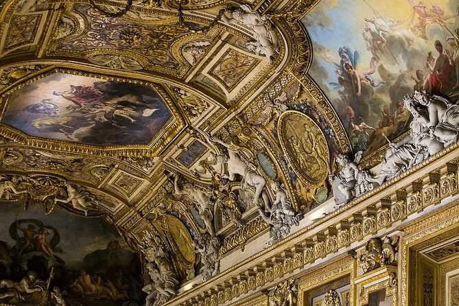 A painted and gilded vaulted ceiling, looking up from a long gallery